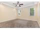 An unfurnished bedroom shows a tray ceiling, neutral carpet, and an abundance of light at 91 Carsons Creek Trl, Wendell, NC 27591
