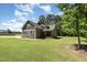 Charming two-story home with stone accents, green siding, and a cozy front porch at 91 Carsons Creek Trl, Wendell, NC 27591