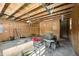 A large garage with concrete floors, plywood walls, and a lawn mower at 91 Carsons Creek Trl, Wendell, NC 27591