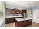 Stylish kitchen showcasing an island, stainless steel appliances, and dark wood cabinetry at 91 Carsons Creek Trl, Wendell, NC 27591