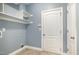 The laundry room has built-in shelves, utility connections, and a neutral color palette at 91 Carsons Creek Trl, Wendell, NC 27591