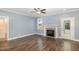 Bright living room with hardwood floors, a fireplace, and ample natural light from the window at 91 Carsons Creek Trl, Wendell, NC 27591