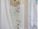 Shower featuring white tiling and adjustable shower head with separate fixtures at 945 St Marys St, Raleigh, NC 27605