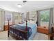 Comfortable bedroom with natural light, a bed with a blue blanket, and a serene atmosphere at 945 St Marys St, Raleigh, NC 27605