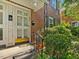 Traditional brick townhouse with white-trimmed windows, black shutters and wrought iron features at 945 St Marys St, Raleigh, NC 27605