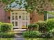 Charming brick townhouse featuring a quaint front entrance and well-maintained landscaping at 945 St Marys St, Raleigh, NC 27605