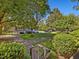 Townhouse complex featuring mature trees, sidewalks, and well-manicured lawns at 945 St Marys St, Raleigh, NC 27605