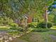 Traditional brick townhouse with manicured landscaping and mature trees offers a welcoming curb appeal at 945 St Marys St, Raleigh, NC 27605