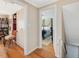 Hallway with hardwood floors, a closet, and view into bedroom at 945 St Marys St, Raleigh, NC 27605