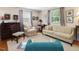 Bright living room with neutral decor, comfortable seating, and a large window at 945 St Marys St, Raleigh, NC 27605