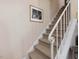 Carpeted stairway with a white handrail, showcasing the home's classic design at 945 St Marys St, Raleigh, NC 27605