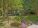 Lush green yard with mature trees and colorful flowerbeds providing a peaceful outdoor space at 945 St Marys St, Raleigh, NC 27605