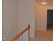 Second floor hallway with wood railing and carpeting at 958 Shining Wire Way, Morrisville, NC 27560