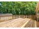 Spacious wooden back deck overlooking private backyard with mature trees and storage shed at 1004 Candlewood Cir, Siler City, NC 27344