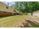 Expansive backyard with lush green grass, mature trees, and a deck, perfect for outdoor entertaining at 1004 Candlewood Cir, Siler City, NC 27344