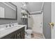 Cozy full bathroom features a shower-tub combo, a vanity, and floating shelves at 1004 Candlewood Cir, Siler City, NC 27344