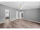 Spacious bedroom with wood-look flooring, ceiling fan, and views to what could be an en-suite bathroom at 1004 Candlewood Cir, Siler City, NC 27344
