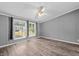 Bedroom with updated flooring and two windows that offer natural lighting at 1004 Candlewood Cir, Siler City, NC 27344