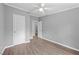 Neutral bedroom with new hardwood flooring, a ceiling fan, and white doors and trim at 1004 Candlewood Cir, Siler City, NC 27344