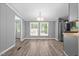 Bright dining area with updated light fixture and flooring that leads to the kitchen at 1004 Candlewood Cir, Siler City, NC 27344