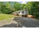 Charming single-story home with front porch and mature trees at 1004 Candlewood Cir, Siler City, NC 27344