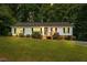 Charming single-story home with a well-manicured lawn and inviting front porch at 1004 Candlewood Cir, Siler City, NC 27344