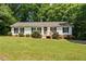 Charming single-story home with a well-manicured lawn and inviting front porch at 1004 Candlewood Cir, Siler City, NC 27344