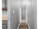 Hallway view of updated gray paint, wood flooring, and butcher block countertop in kitchen at 1004 Candlewood Cir, Siler City, NC 27344