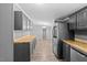 Spacious kitchen features stainless steel appliances, gray cabinetry, and butcher block countertops at 1004 Candlewood Cir, Siler City, NC 27344