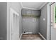 Functional laundry room with overhead cabinets, utility closet and wood-look flooring at 1004 Candlewood Cir, Siler City, NC 27344