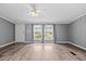 Spacious living room with large windows providing ample natural light and hardwood flooring at 1004 Candlewood Cir, Siler City, NC 27344