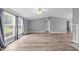 Bright living room with large windows, modern flooring, and an open layout for versatile living at 1004 Candlewood Cir, Siler City, NC 27344