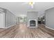 Open-concept living room featuring a fireplace, modern floors, and abundant natural light at 1004 Candlewood Cir, Siler City, NC 27344