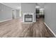 Open living space with a fireplace, modern flooring, and seamless access to the kitchen at 1004 Candlewood Cir, Siler City, NC 27344