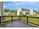 Spacious deck overlooking a lush backyard with mature trees and manicured lawn at 1009 Magnolia Leaf Ct, Apex, NC 27502