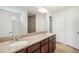 Bathroom vanity with dual sinks and stone countertops, plus shower with glass door at 1009 Magnolia Leaf Ct, Apex, NC 27502