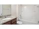 Bathroom features a tub, a shower, and a vanity with granite countertops at 1009 Magnolia Leaf Ct, Apex, NC 27502