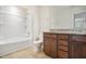 Bathroom with granite-topped vanity, and a shower-tub combination at 1009 Magnolia Leaf Ct, Apex, NC 27502