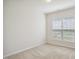 A bright bedroom featuring a neutral carpet and a window with blinds at 1009 Magnolia Leaf Ct, Apex, NC 27502