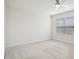 Bright bedroom with neutral carpet, ceiling fan, and large windows at 1009 Magnolia Leaf Ct, Apex, NC 27502