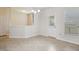 Bright dining area with tile floors, chandelier, and large windows with door access at 1009 Magnolia Leaf Ct, Apex, NC 27502
