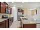 Modern kitchen featuring granite countertops, stainless steel appliances, and spacious island at 1009 Magnolia Leaf Ct, Apex, NC 27502