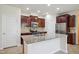 Modern kitchen featuring granite countertops, stainless steel appliances, and spacious island at 1009 Magnolia Leaf Ct, Apex, NC 27502