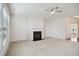 Bright living room with neutral carpet, ceiling fan and fireplace with mantle at 1009 Magnolia Leaf Ct, Apex, NC 27502