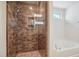 Bathroom shower with rainfall head, built-in niche, and glass door at 1009 Magnolia Leaf Ct, Apex, NC 27502