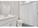 Clean bathroom features a white vanity, toilet, and shower with a white shower curtain at 101 Rostova Way, Holly Springs, NC 27540