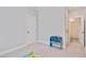 Clean, bright bedroom with a blue storage rack, carpet, and access to the bathroom at 101 Rostova Way, Holly Springs, NC 27540