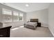 Bright bedroom featuring a comfortable bed, neutral carpet, and lots of natural light from the windows at 101 Rostova Way, Holly Springs, NC 27540