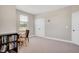Bright bedroom featuring neutral walls, carpeted floors, a large window, and a built-in desk area at 101 Rostova Way, Holly Springs, NC 27540