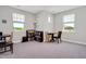 Bonus room with multiple windows, a small table, and a bookcase at 101 Rostova Way, Holly Springs, NC 27540